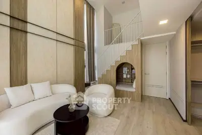 Modern living room with high ceilings and stylish furniture in a contemporary apartment.
