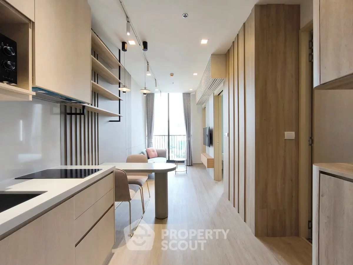 Modern open-layout kitchen and living room with sleek design and natural light
