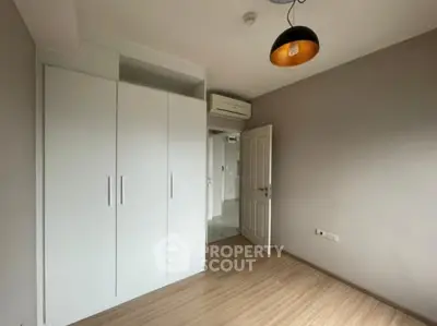 Spacious bedroom with modern wardrobe and stylish lighting