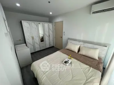 Modern bedroom with stylish wardrobe and cozy bed in bright apartment