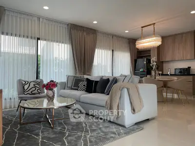 Luxurious modern living room with elegant decor and open kitchen layout, perfect for stylish living.