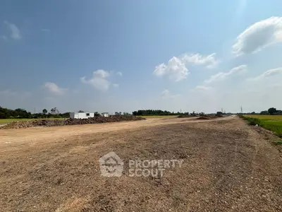 Expansive land plot with clear skies, ideal for development opportunities.