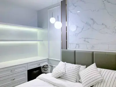 Modern bedroom with elegant marble accent wall and stylish lighting