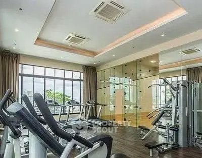 Modern gym with state-of-the-art equipment and large windows offering a scenic view.