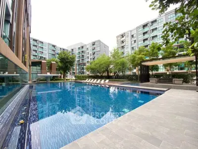 Luxurious condominium pool area with modern design and lush greenery