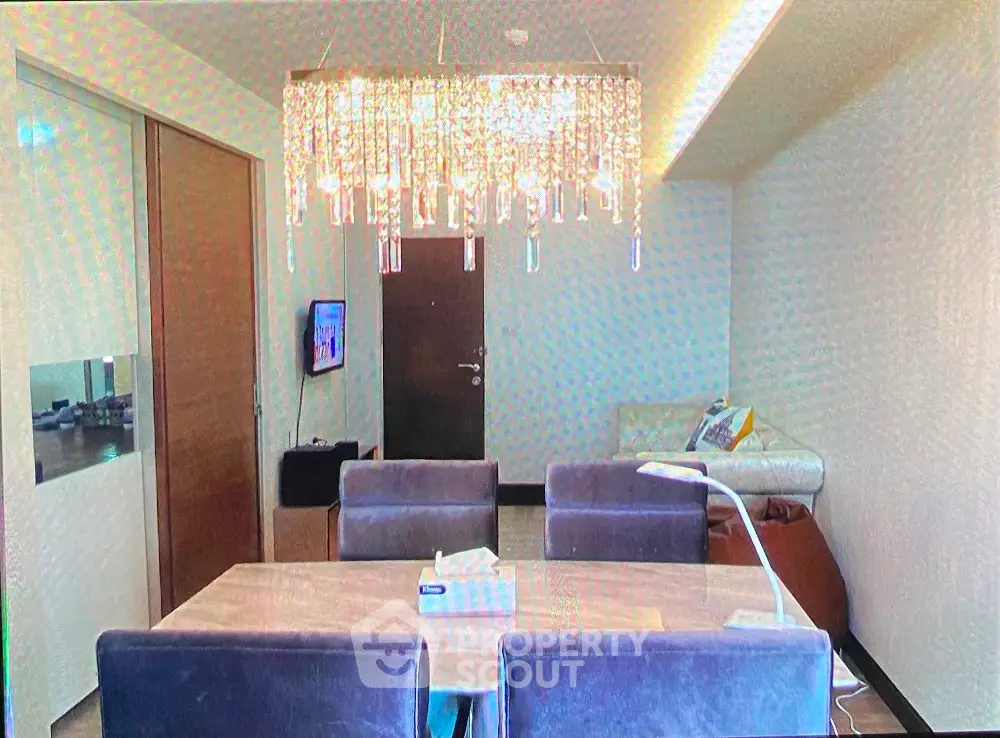 Modern living room with elegant chandelier and cozy seating area