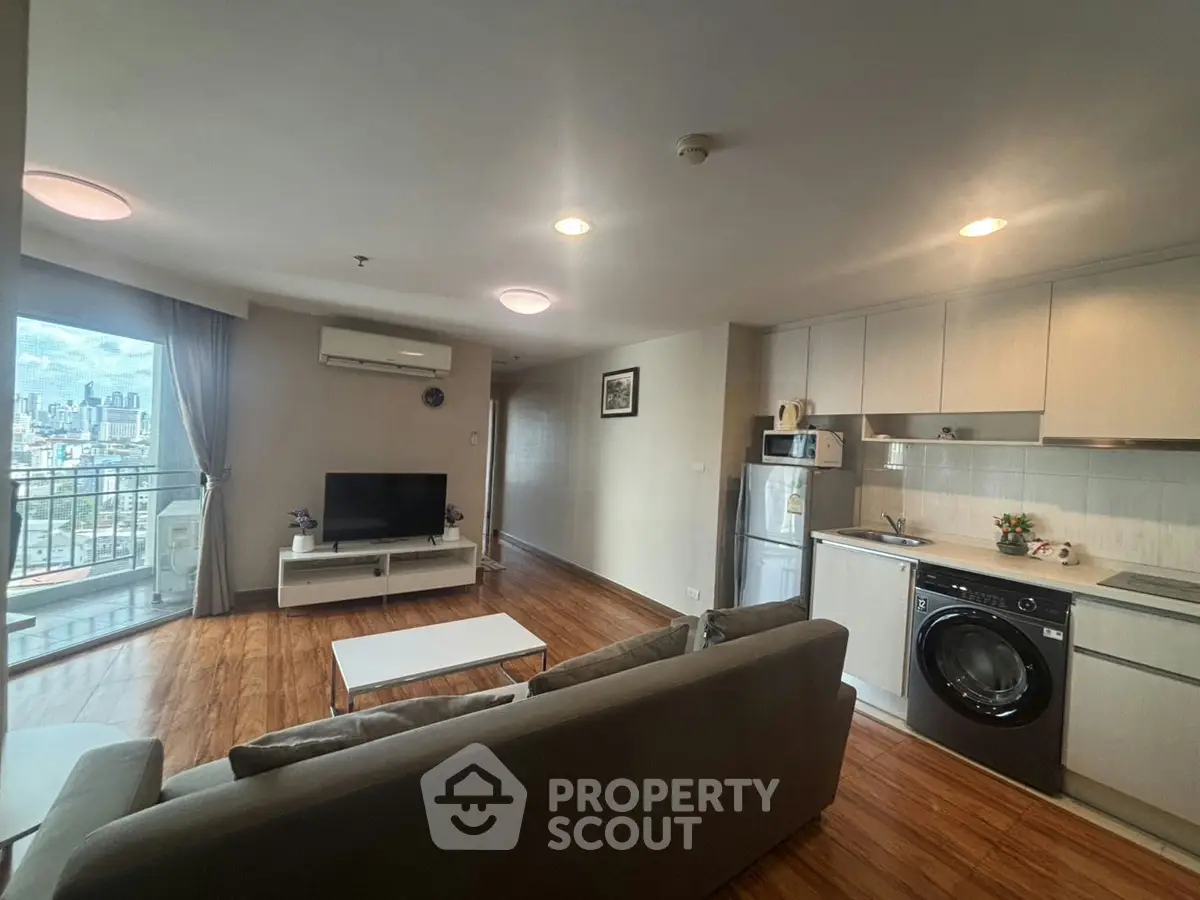 Spacious modern living room with open kitchen and city view balcony