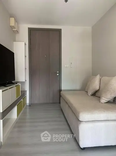 Modern living room with sleek sofa and TV unit, perfect for cozy relaxation.