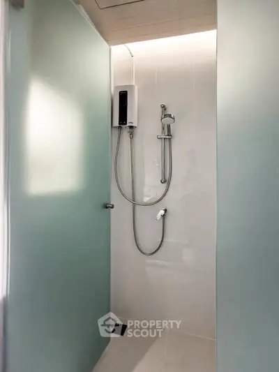 Modern minimalist bathroom with sleek shower design and frosted glass panels.