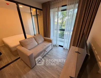 Cozy living room with sofa and large window in modern apartment