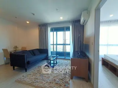 Modern living room with plush rug and balcony view in stylish apartment