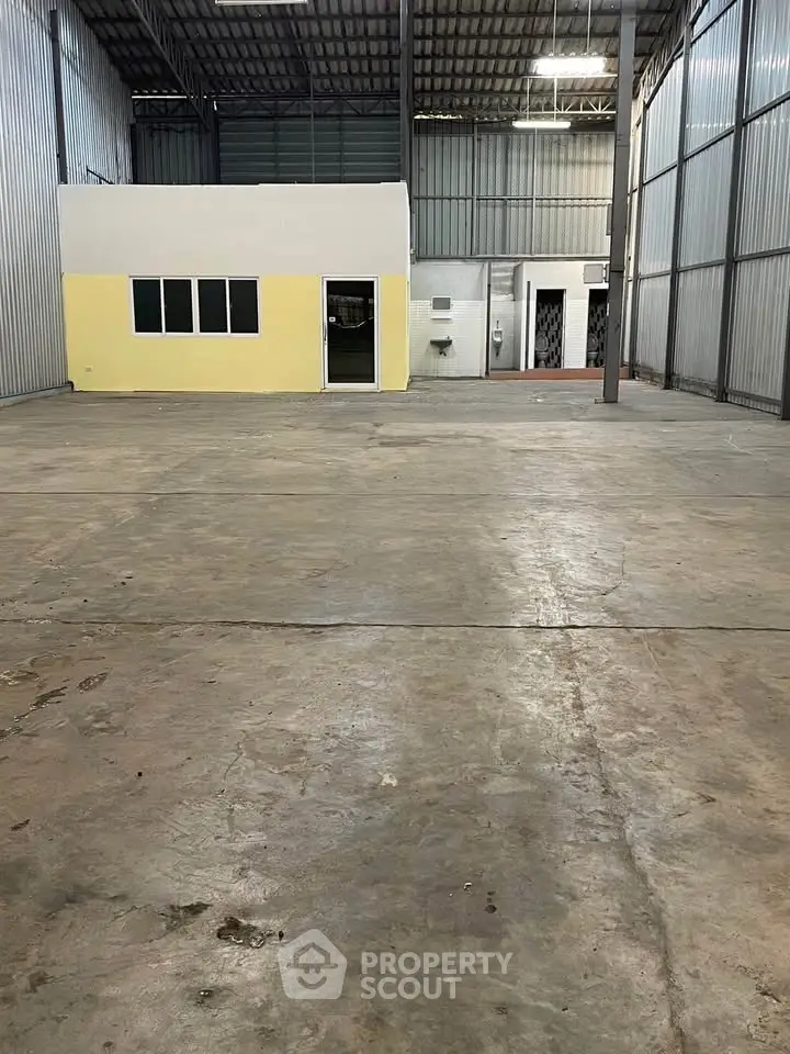 Spacious industrial warehouse with office space and high ceilings