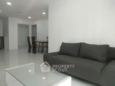Modern minimalist living room with sleek furniture and bright lighting