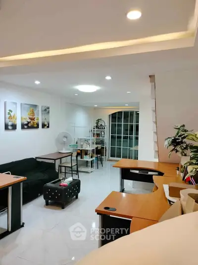 Spacious modern living room with stylish decor and ample natural light