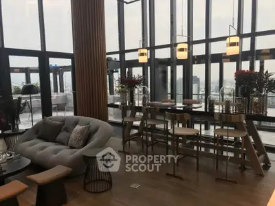 Luxurious penthouse living room with panoramic city views and modern decor.