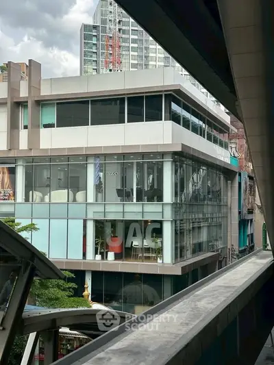 Modern commercial building with glass facade in urban setting