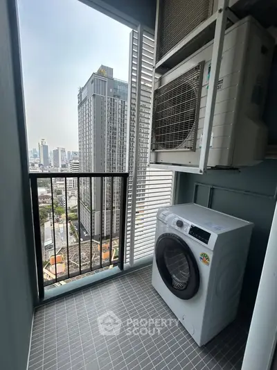 High-rise apartment balcony with city view and washing machine setup.