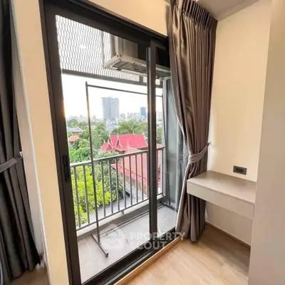 Charming balcony view with cityscape and lush greenery, perfect for relaxation and enjoying the outdoors.