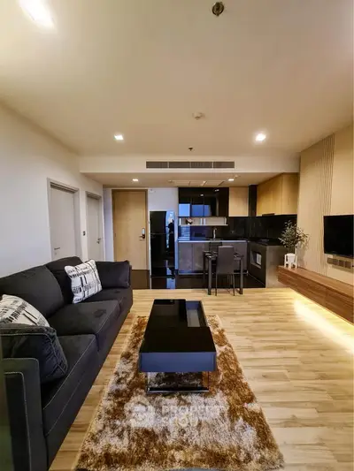 Modern open-plan living room with sleek kitchen and stylish decor