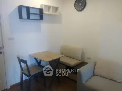 Cozy living room with minimalist furniture and wall clock