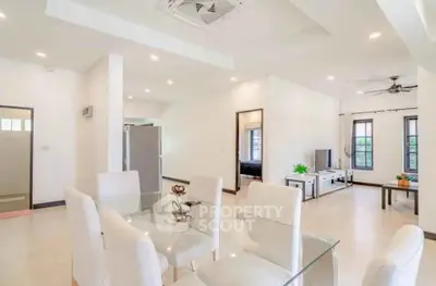 Spacious open-plan living and dining area with modern decor and natural light.