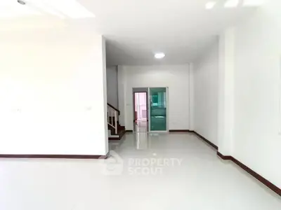 Spacious modern interior with glossy white floors and staircase, ideal for customization.