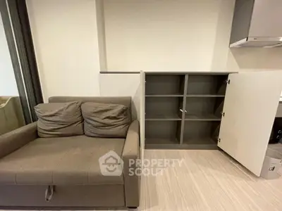 Modern living room with stylish sofa and open storage cabinet