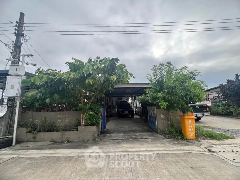 Charming suburban home with driveway and lush greenery, perfect for family living.
