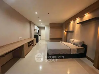 Spacious modern bedroom with sleek design and ample storage in a contemporary apartment.