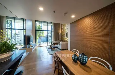 Modern living room with stylish decor and large windows offering city views.