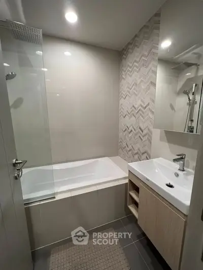 Modern bathroom with stylish tiles and bathtub in a contemporary apartment.
