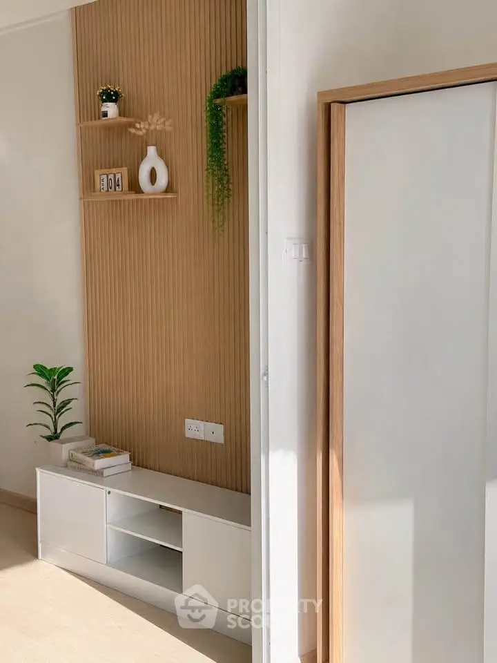 Modern interior with stylish wooden paneling and sleek storage solutions in a bright room.