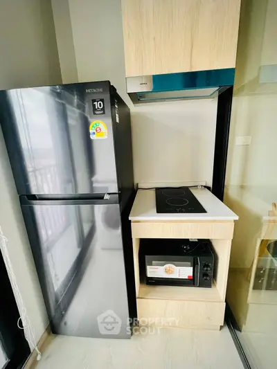 Modern kitchen with sleek appliances and compact design