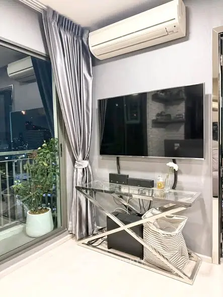 Modern living room with sleek TV setup and balcony view