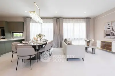 Elegant open-plan living and dining area with modern decor and natural light.