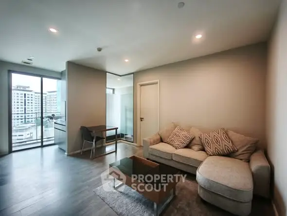 Modern living room with cozy sofa and city view balcony
