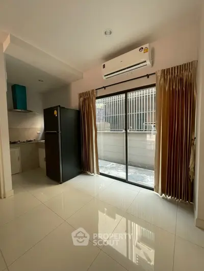 Modern kitchen with open layout and large sliding doors to balcony