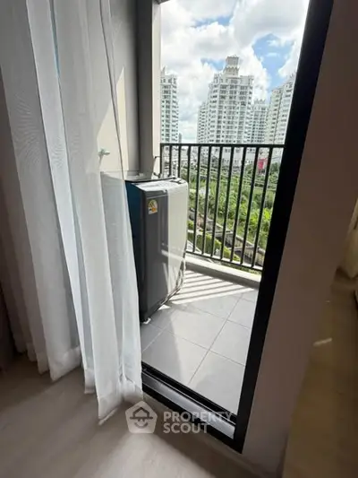 Modern balcony with washing machine and city view, perfect for urban living.