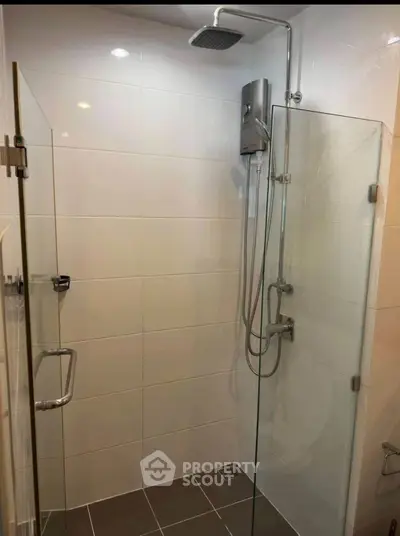 Modern bathroom with glass shower enclosure and sleek fixtures