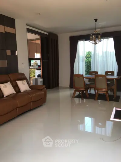 Spacious living room with elegant dining area and natural light