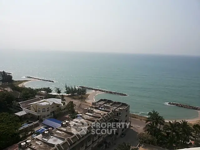 Stunning ocean view from high-rise building overlooking serene beach and coastline.