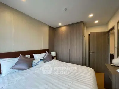 Cozy bedroom with modern decor and ample natural light