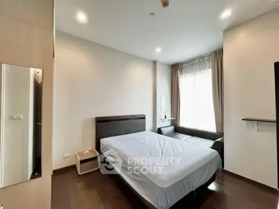 Spacious bedroom with modern furnishings and natural light