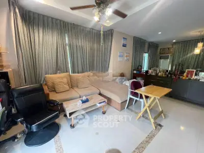Spacious living room with modern decor and ample natural light, featuring a cozy sofa and stylish furnishings.