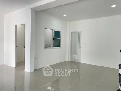 Spacious modern interior with sleek tiled flooring and neutral walls, ideal for customization.