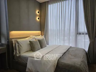 Luxurious bedroom with elegant decor and large window offering city views