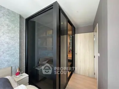 Modern bedroom with glass-enclosed study area and stylish decor