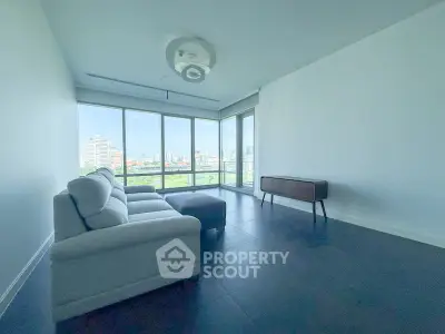 Spacious living room with panoramic city view and modern furniture.