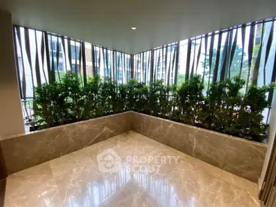 Luxurious marble-floored balcony with lush greenery and modern design.