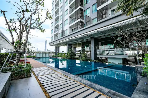 Luxurious modern apartment building with stunning pool and lush greenery